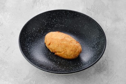 Kiev or pozharskaya cutlet on a plate.