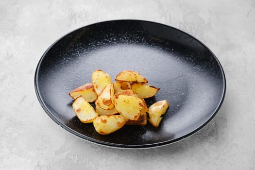 Garnish to the main dish - slices of boiled potatoes fried in oil