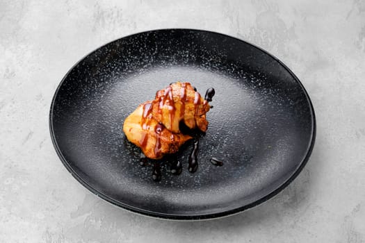 Fried chicken meat with teriyaki sauce on a plate