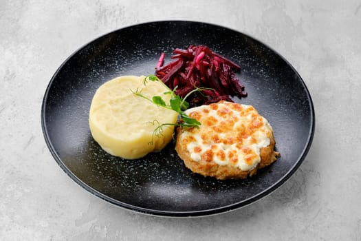 Kiev citlet with mashed potato and pickled beetroot on a plate