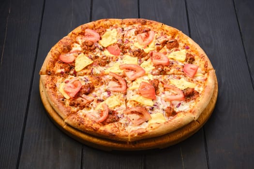 Pizza with minced meat, cheddar cheese and tomato