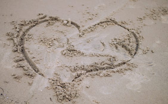 Love sign on sand. Love heart symbol in sand on tropical beach. Holidays Backgrounds Textures. Puri, Odisha, India