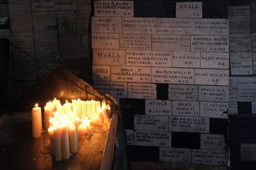 Lighting candles in chapel of Our Lady from the Kamenita vrata (Stone Gate) in Zagreb to remember and honor the deceased loved ones