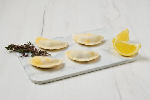 Semifinished frozen salmon dumplings on serving board