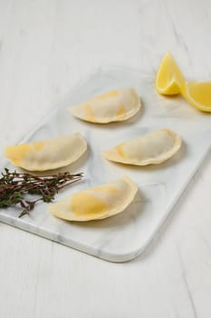 Semifinished frozen salmon dumplings on serving board