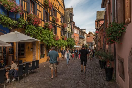 People on street in medieval village of Riquewihr, Alsace, France