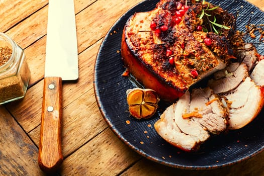 Tasty fried pork belly with spices and herbs. Fatty piece of meat on old table