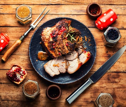 Tasty fried pork belly with spices and herbs. Fatty piece of meat on old table