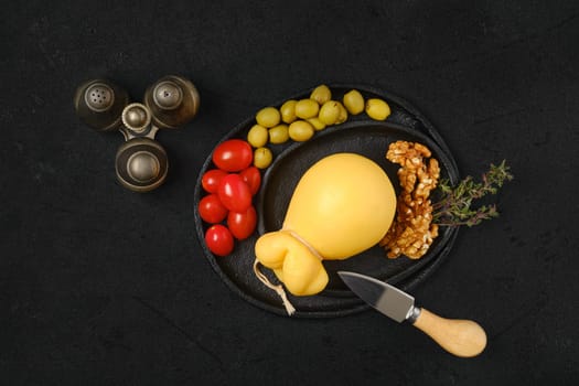 Overhead view of pulled caciocavallo yellow cheese on a plate