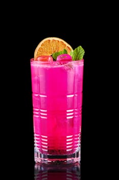 Cold lemonade with dragon fruit, orange and coconut juice isolated on black background