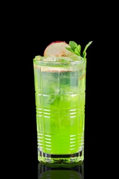 Cold lemonade with tarragon, apple and mint isolated on black background
