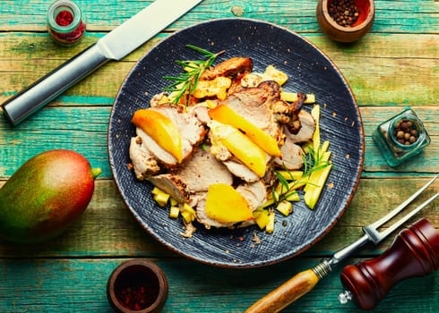 Delicious grilled meat with mango and cheese.