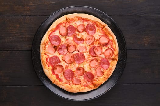 Simple pizza with sausages, top view