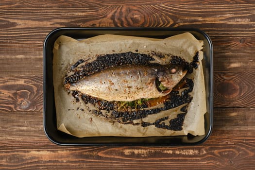 Baked sea yellow tailed mackerel in baking tray, top view