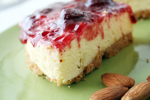 cheesecake slice with almonds in dish