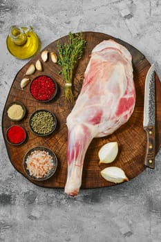 Raw lamb shoulder chump on butcher's cutting log