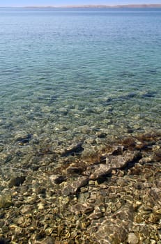 clear water shows stony bottom/ground of the sea/ocean