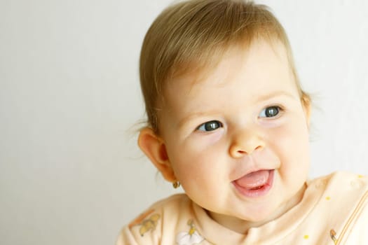 Small baby laughing on the bright background