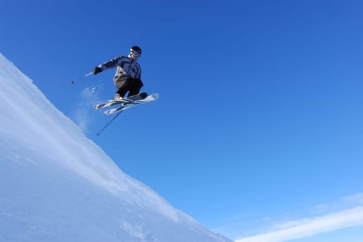 Skier flying off a corncie