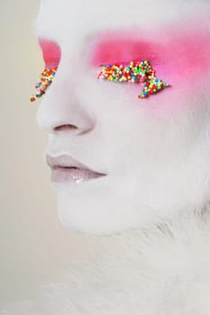 white model with candy on eyes