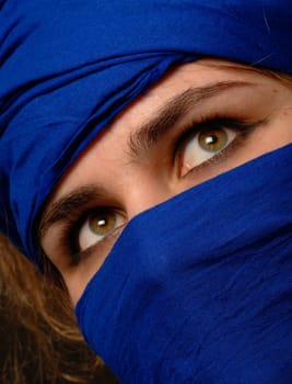 beautiful eyes surrounded by blue scarf