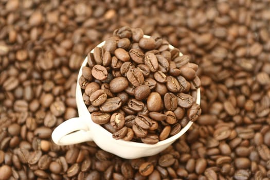 Full cup with grains of coffee