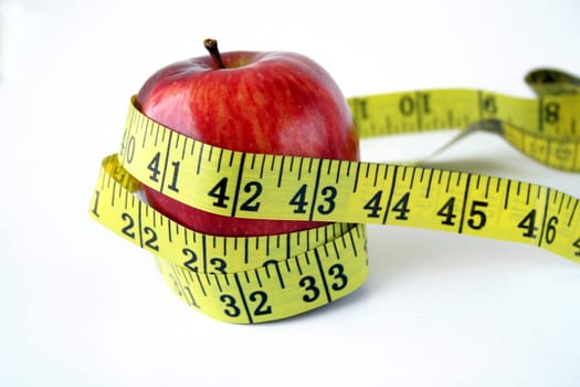 Isolated Apple with measuring tape around in white background