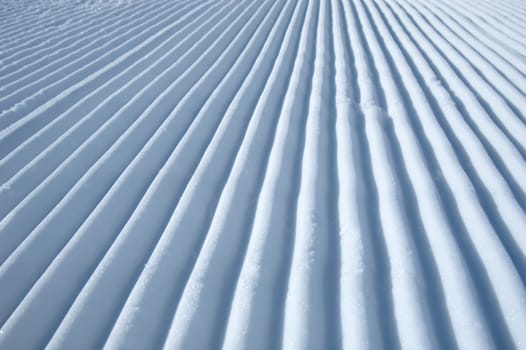 lines in the snow made by a snowmobile