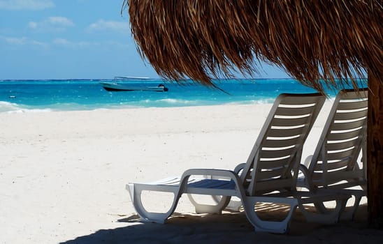 two seats under wicker umbrella