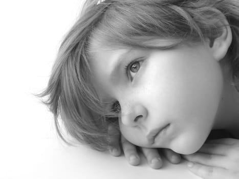 black and white portrait of the small pretty thoughtful girl