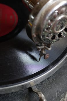 An antique record player sitting on the attic floor.