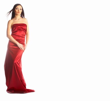 Lovely girl in red dress standing isolated on white background