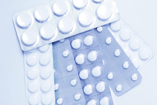 Pills as background in blue tone