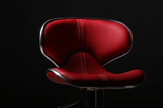 tall red bar chair in a studio