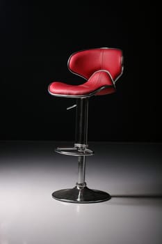 tall red bar chair in a studio