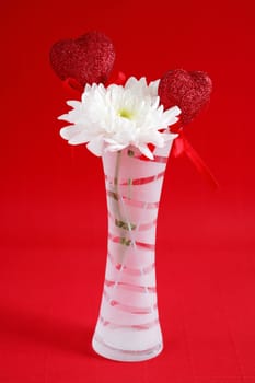 Two hearts with flower in red tone