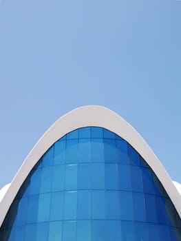 Public Building under a blue sky with beautiful lines and curves.