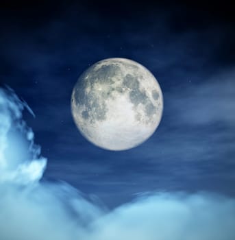 An image of the moon in the cloudy night time sky.