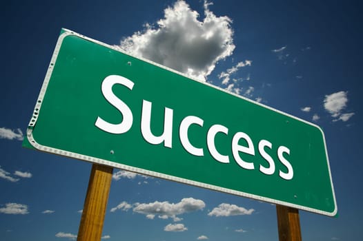 Success Road Sign with dramatic blue sky and clouds.