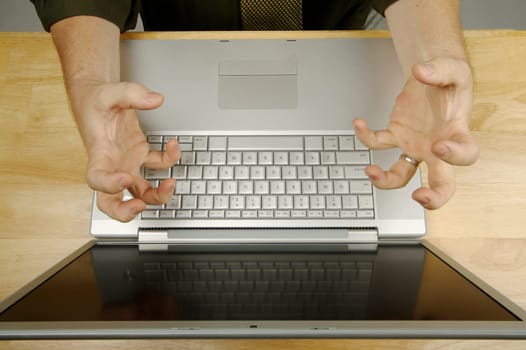 Frustrated businessman shows his frustration while working on his laptop.