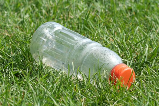 Empty bottle at a field