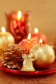 Beautiful Christmas candles in golden and red tones as decoration