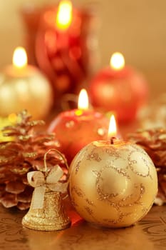 Beautiful Christmas candles in golden and red tones as decoration