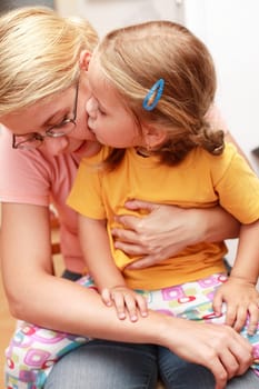 Cute little girl kissing her Mom