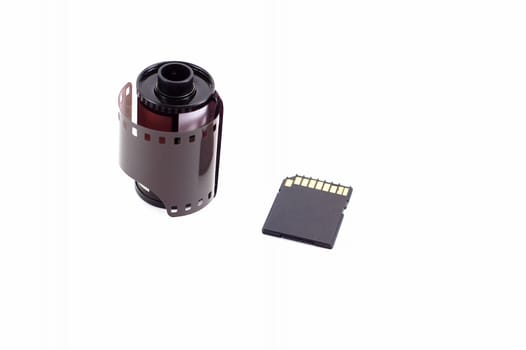 Roll of film next to a SD memory card