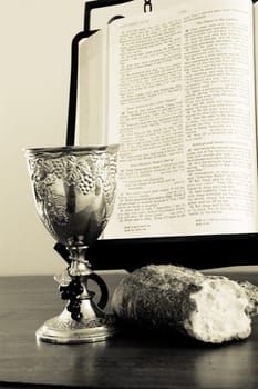 Bible, bread, and wine cup. Symbol of the Lord's Supper.