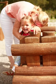 Mother and her daughter have fun at the playground
