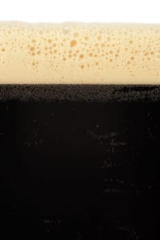 A macro image of a glass of stout beer or bitter.
