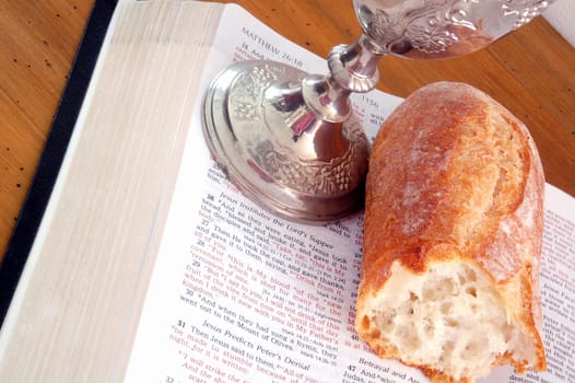 Bible, bread, and wine cup. Symbol of the Lord's Supper.