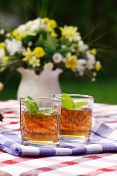 Fresh herbal tea served outdoor in garden or restaurant